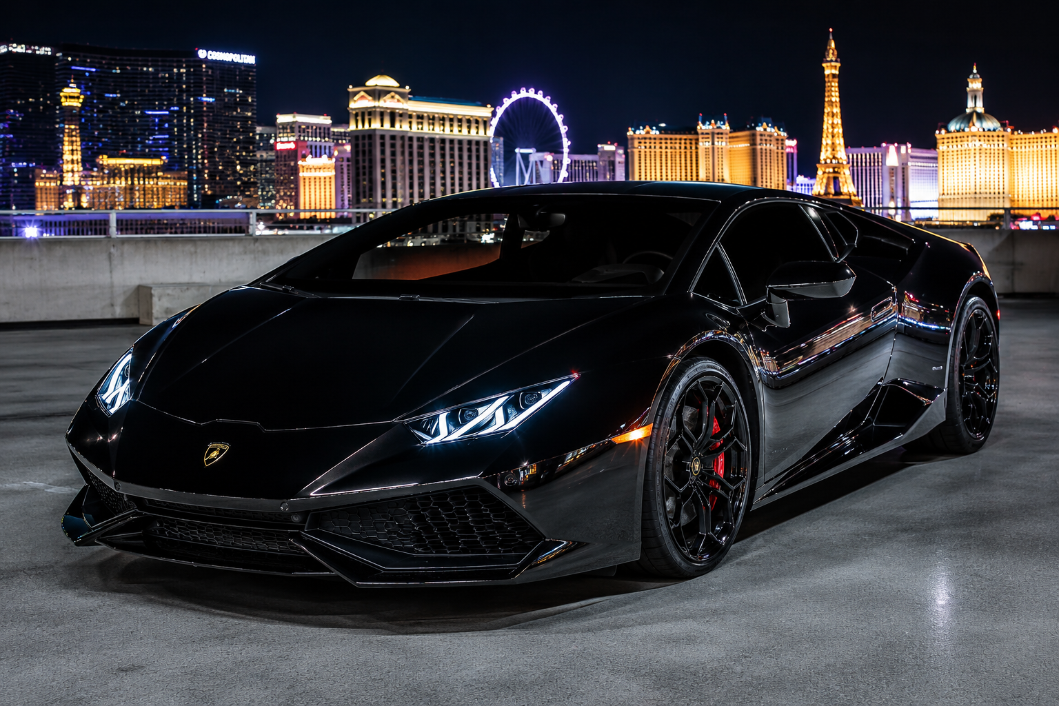 Black Lamborghini Huracán on a rooftop with the Las Vegas Strip skyline at night